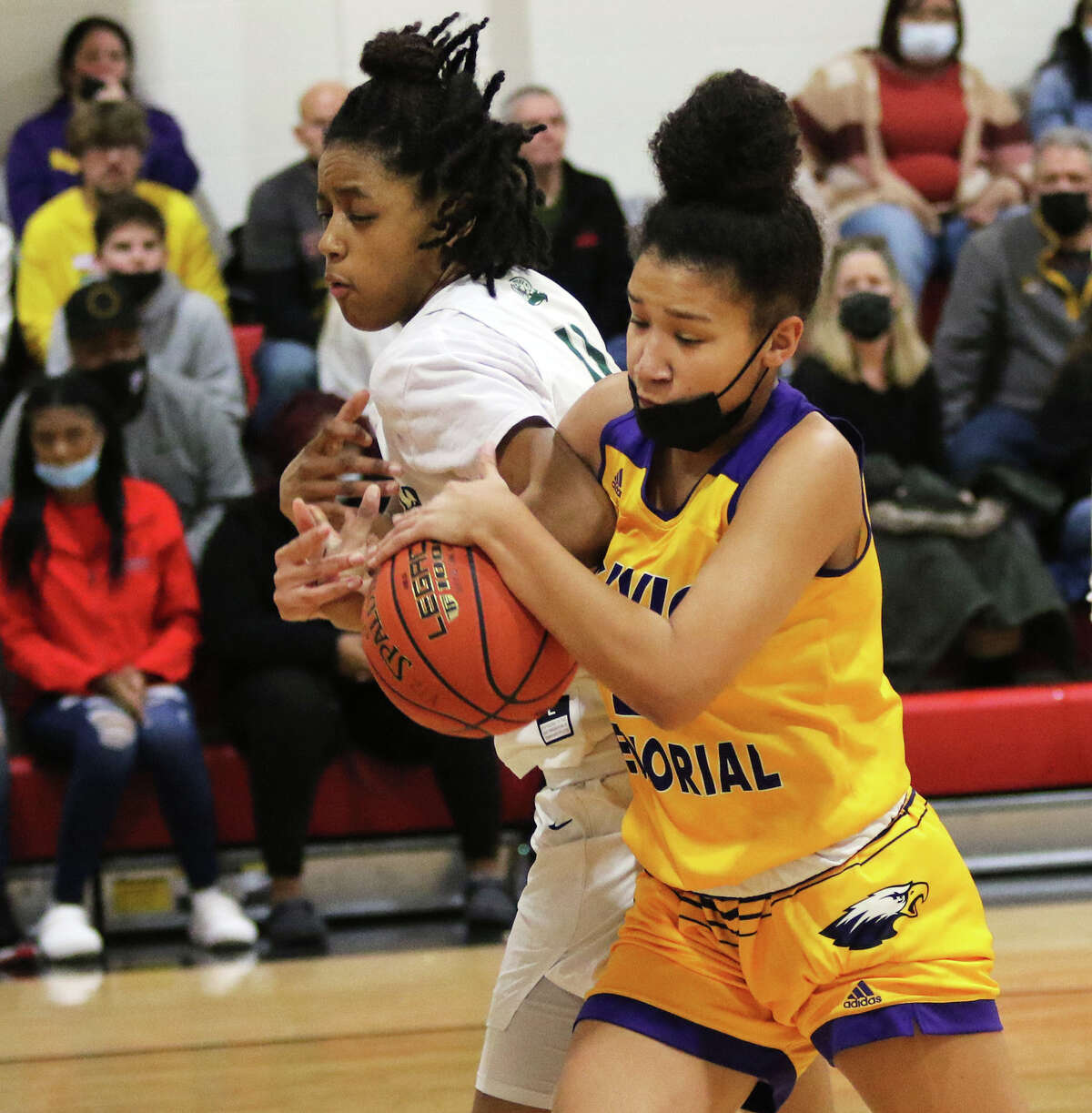 CM's Maya Tuckson (right) battles Whitfield's Brooklyn Rhodes to retain possession of the basketball Sunday night in the quarterfinals of the Visitation Christmas Tournament in St. Louis.