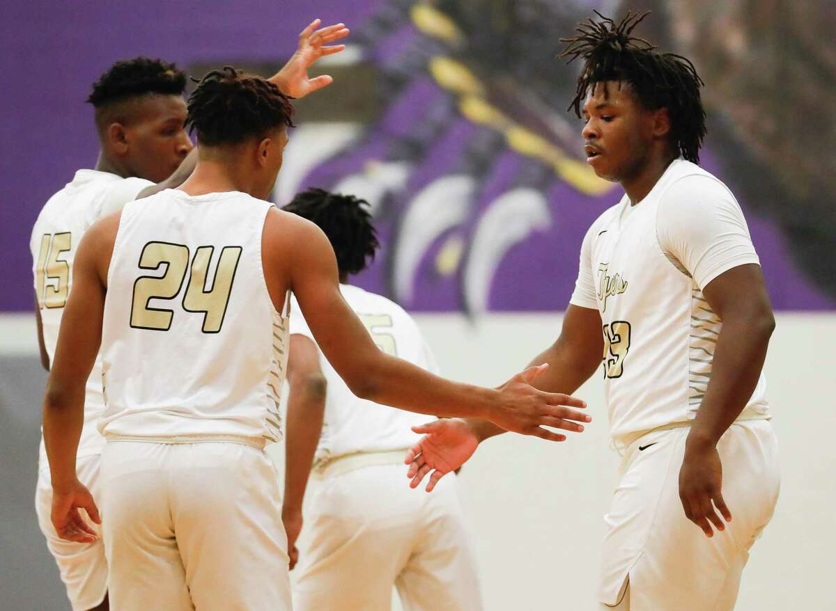 Conroe forward Kamari Weatherspoon (33) gets a high-five from guard Rashaad Salih (24) after drawing a foul during the championship game of the Montgomery Schurr Insurance Holiday Classic at Montgomery High School, Saturday, Dec. 11, 2021, in Montgomery.