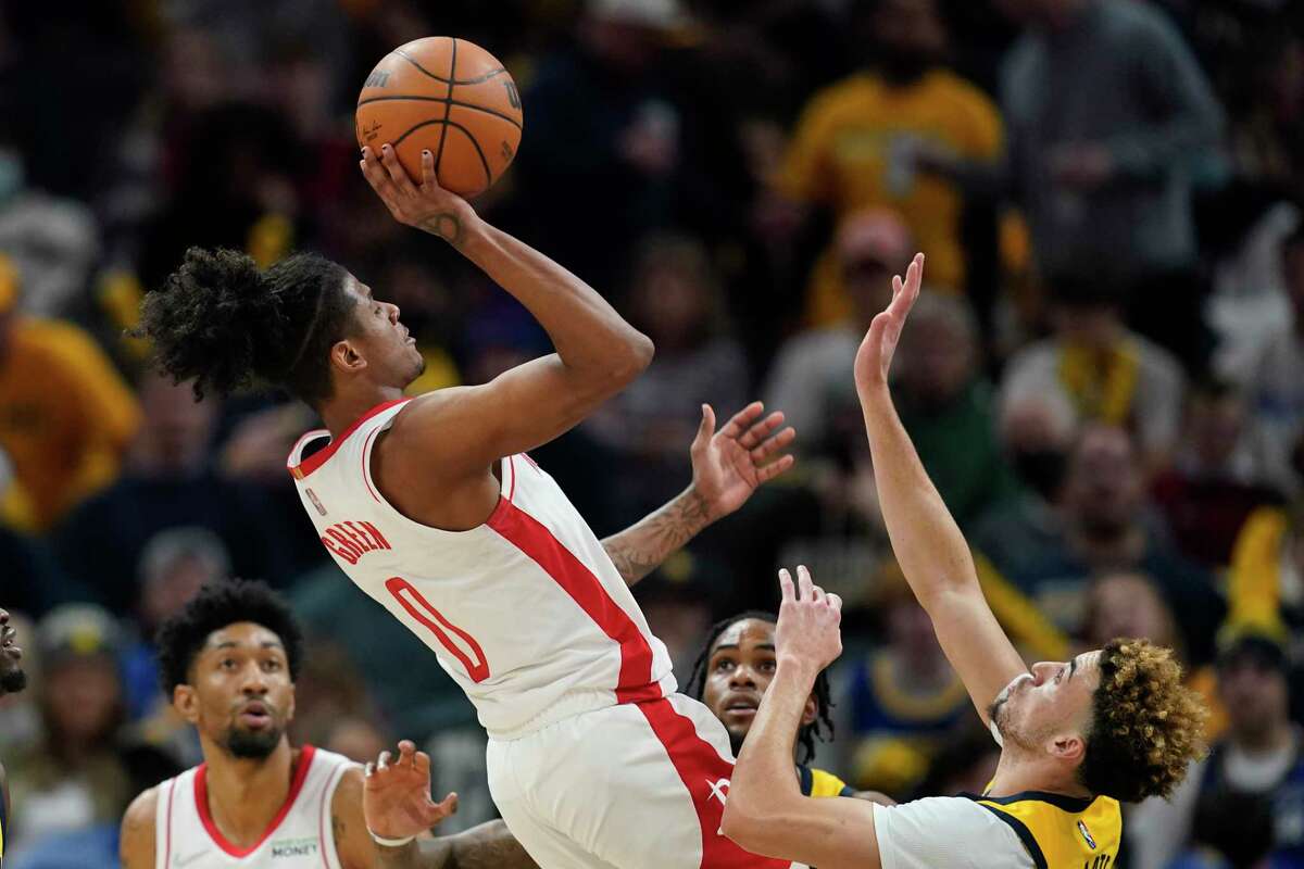 Houston Rockets' Jalen Green (0) shoots over Indiana Pacers' Chris Duarte (3) during the second half of an NBA basketball game, Thursday, Dec. 23, 2021, in Indianapolis. (AP Photo/Darron Cummings)