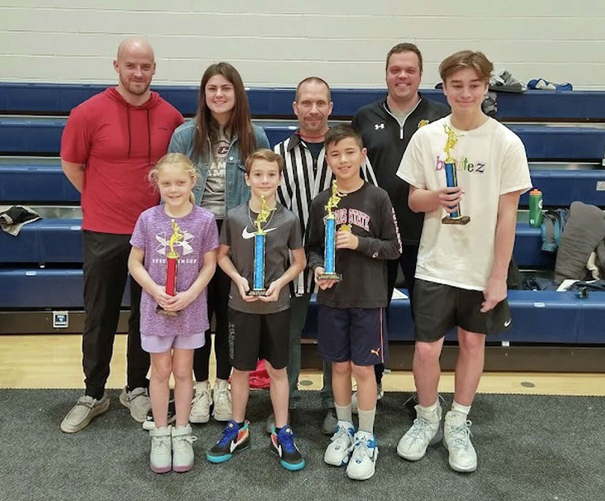 Pictured in the front row, from left to right are winners Hadley Kostecki, Pierson Dunn, Reid Coles, and Max Bollman. In the back row from left to right is Jeff Scarpelli, Katie Scarpelli, Hoop Shoot Director Mark Schriner, and Jason Kostecki. 