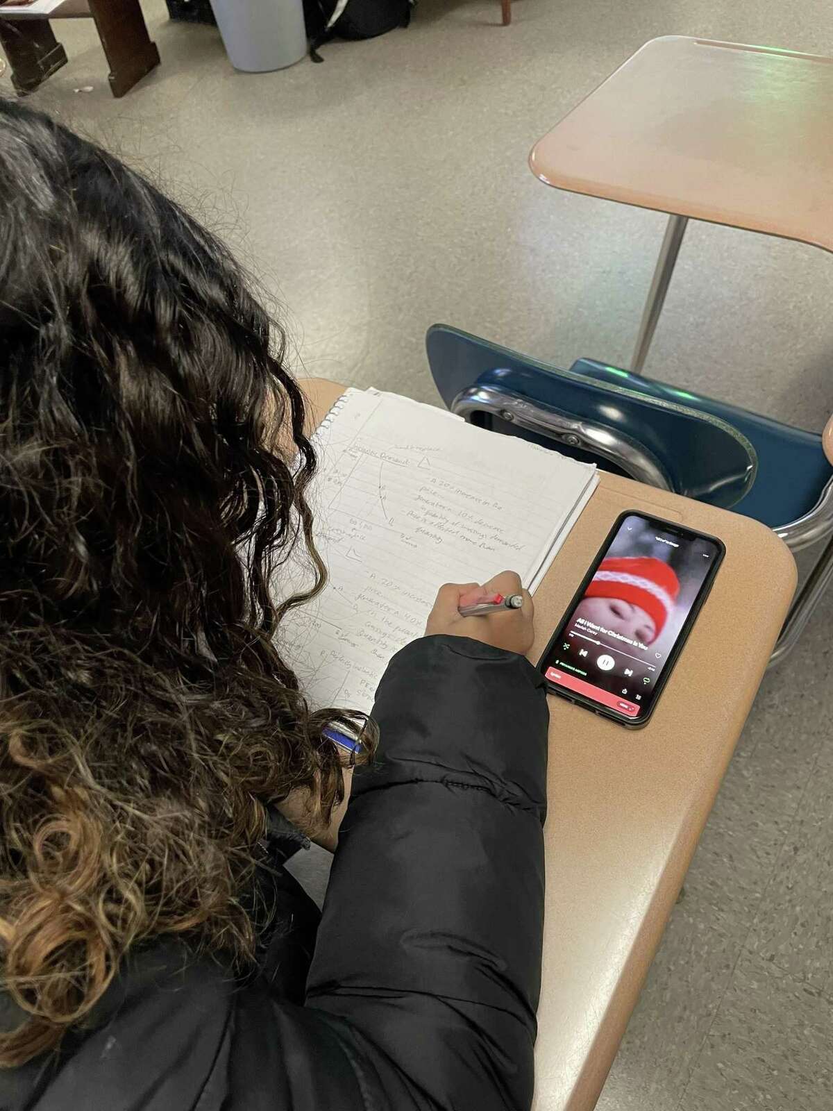 Stamford High School senior Priyanka Umamaheswaran listens to Mariah Carey’s iconic holiday song “All I Want for Christmas Is You” during class.