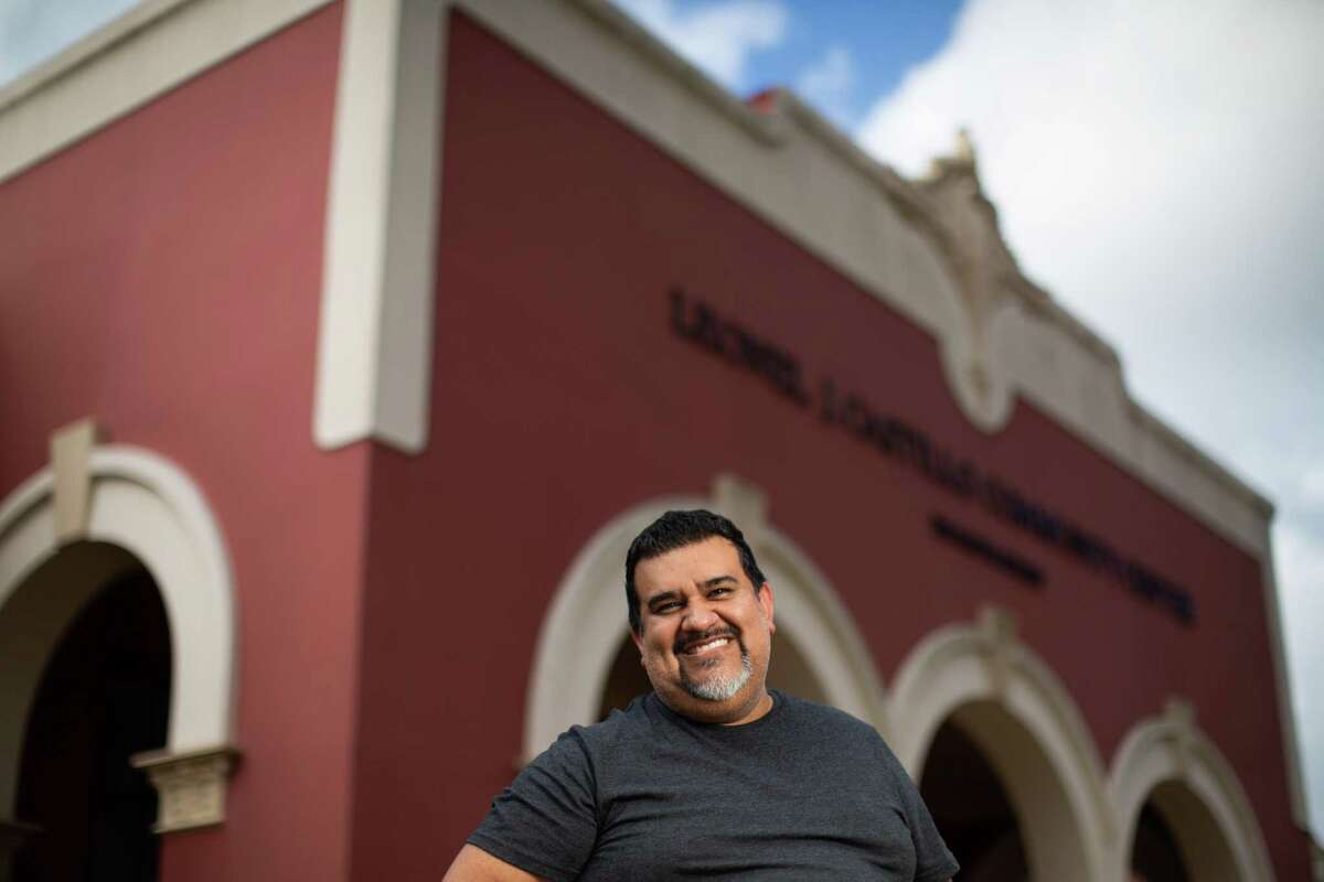 Lupe Mendez, the 2022 Texas Poet Laureate, stands in front of the Leonel Castillo Community Center, Tuesday, Dec. 14, 2021, in Houston. The Leonel Castillo Community Center used to be a huelga school which it was a place set up as an alternative school in Houston so Mexican-American students who were part of strikes could continue their education in the 1970s. The strikes were against the Houston Independent School District (HISD).
