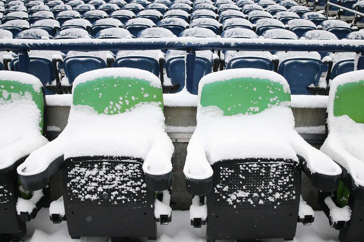 SEATTLE, WASHINGTON - DECEMBER 26: Seats at Lumen Field with snow on them before the game between the Seattle Seahawks and Chicago Bears on December 26, 2021 in Seattle, Washington. (Photo by Abbie Parr/Getty Images)