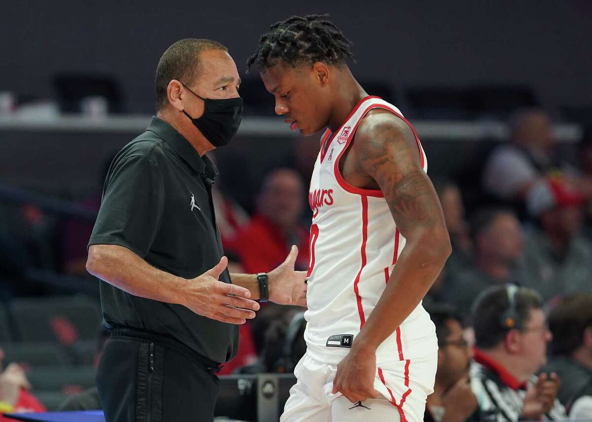 Houston Cougars head coach Kelvin Sampson talks to Houston Cougars guard Marcus Sasser (0), who will miss the rest of the season with a foot injury.