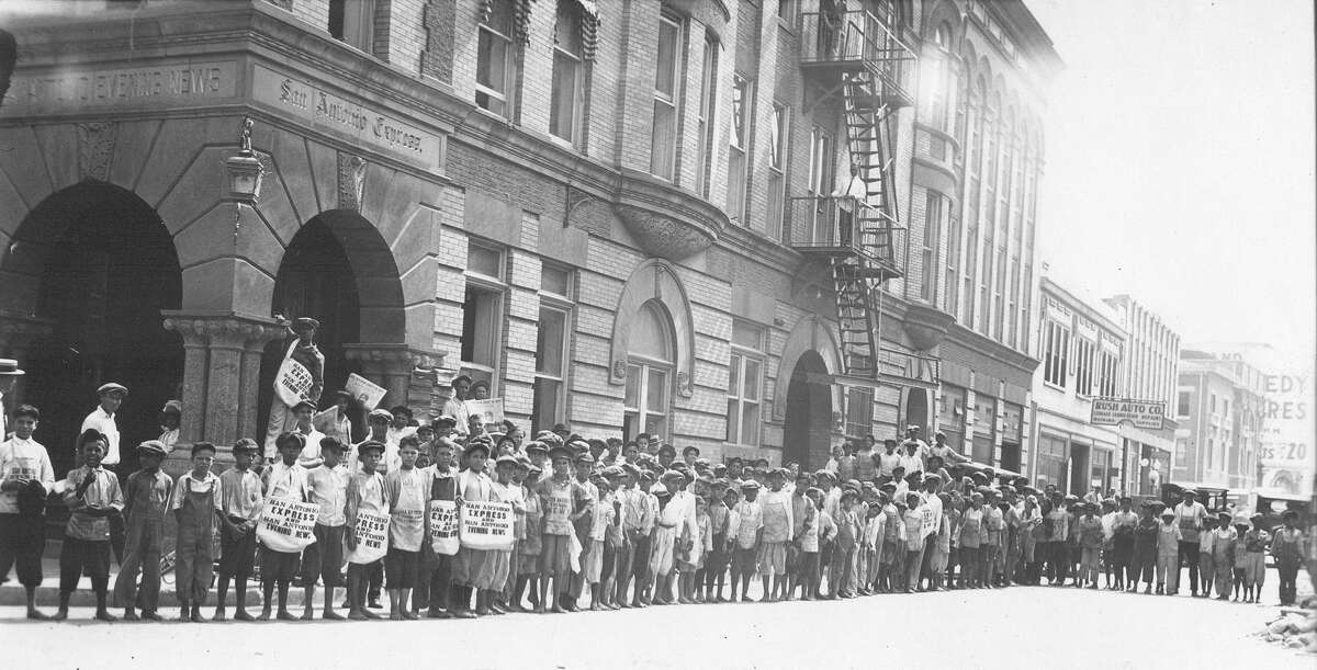 Newspaper carriers gather outside a building that housed the San Antonio Express and San Antonio Evening News from 1895 to 1929.