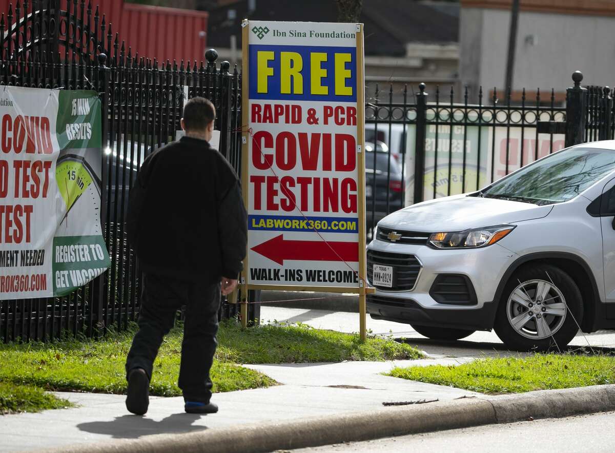Cars turn into a Covid-19 testing site at an Ibn Sina Foundation clinic, Monday, Dec. 27, 2021, in Houston.