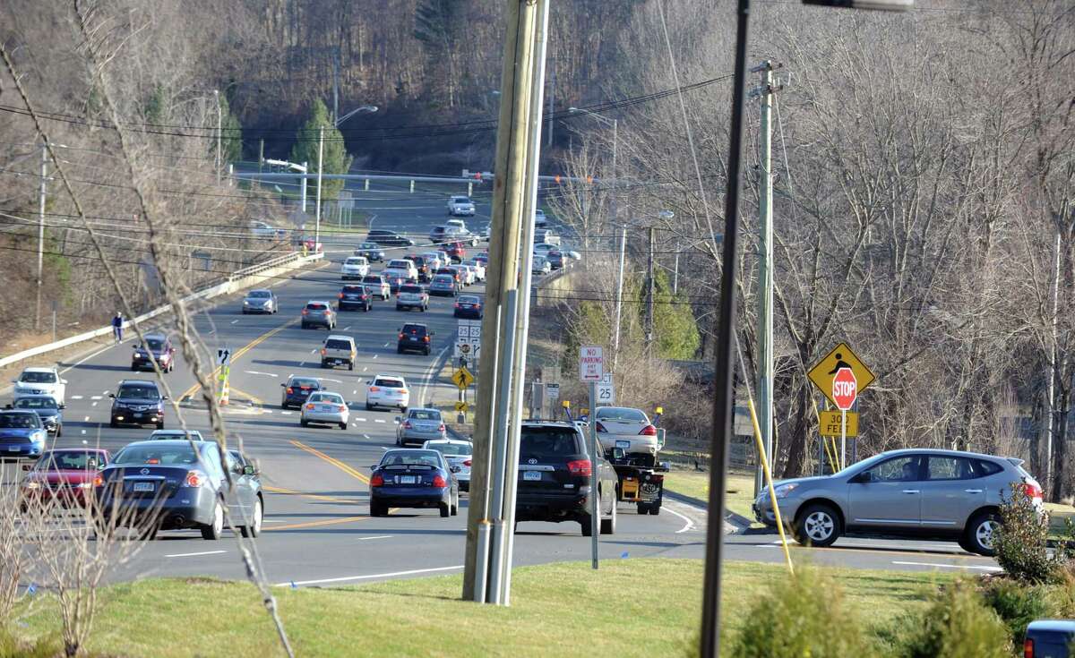 A car waits for an opening to turn left onto Rt. 111 while leaving the new shopping center in Trumbull, near the border with Monroe, Wednesday, April 9, 2014.