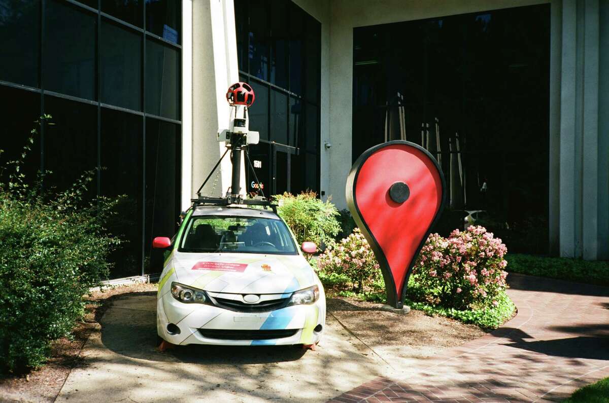 A Google Streetview car and an oversized Google Maps pin sit parked in front of the Google Maps building at the Googleplex, the Silicon Valley headquarters of search engine and technology company Google Inc. in Mountain View, California on April 14, 2018.