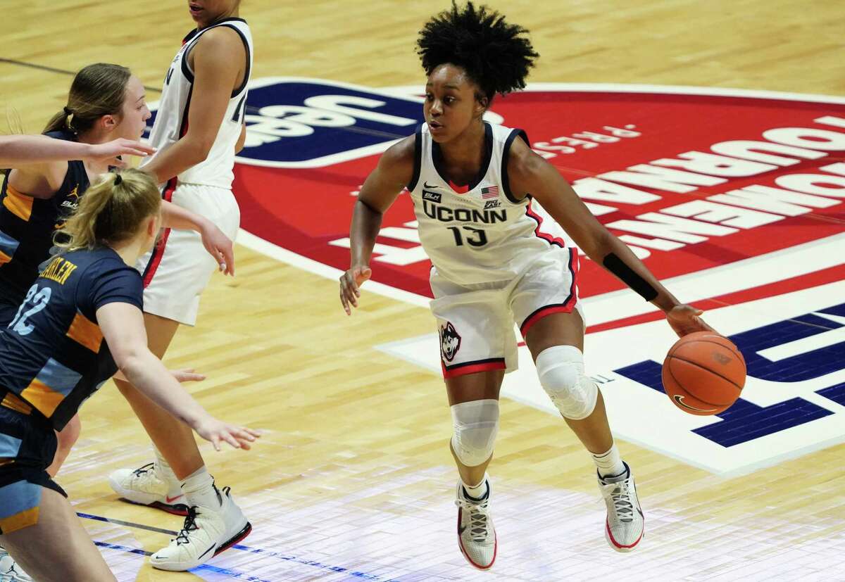 UConn guard Christyn Williams (13) moves the ball against Marquette on March 8. The Huskies’ game against Marquette scheduled for Wednesday at the XL Center was canceled due to COVID issues at Marquette.