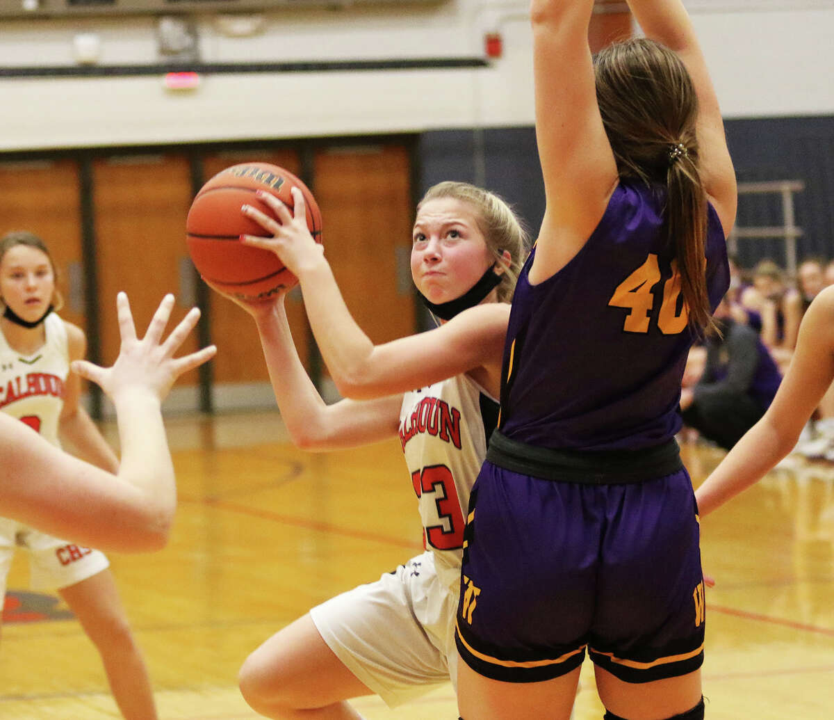 Calhoun's Jaelyn Hill puts up a shot in the lane around Williamsville's Charlene Gleason (40) on Monday at the Carlinville Holiday Tournament.