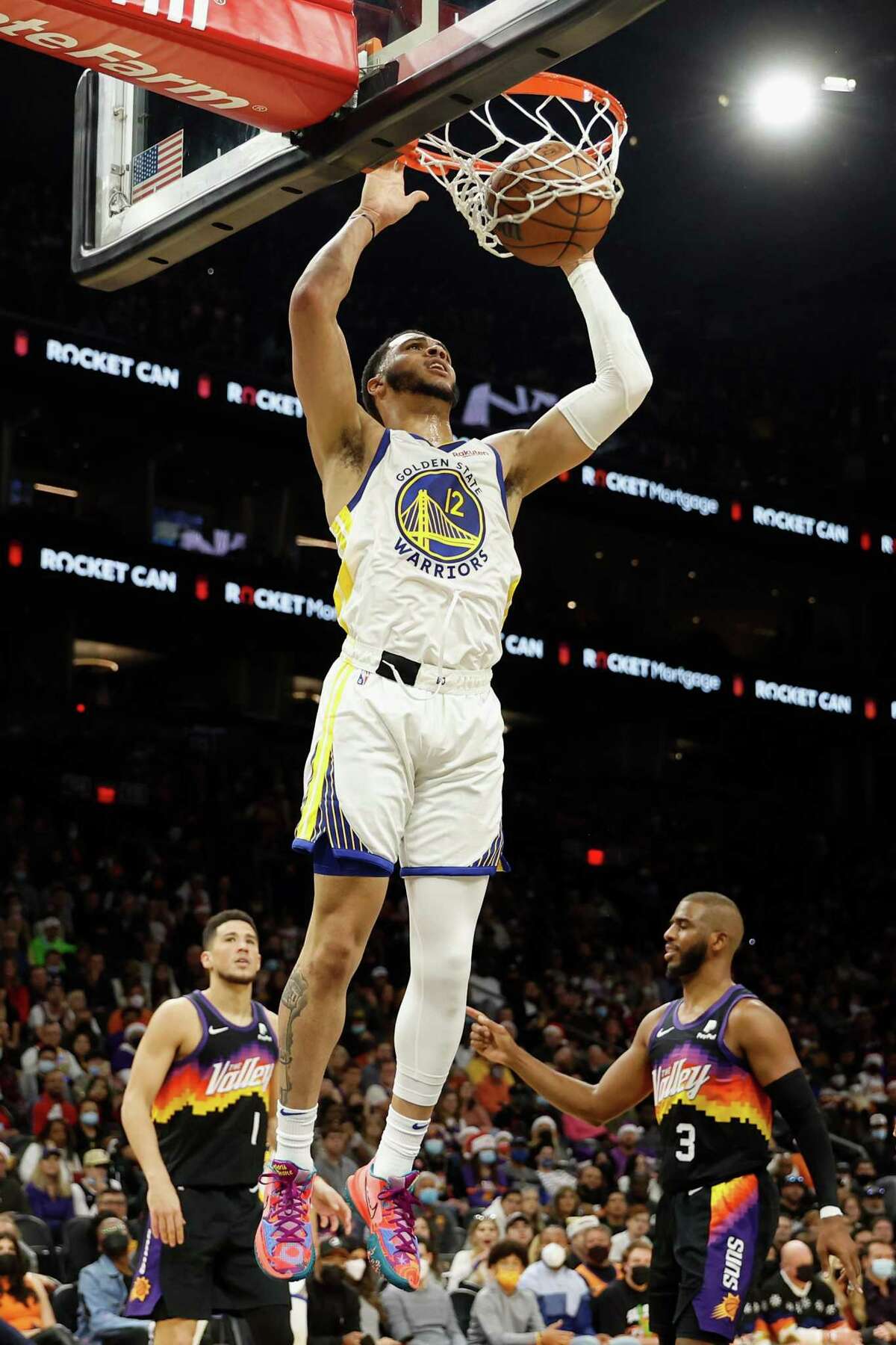 PHOENIX, ARIZONA - DECEMBER 25: Quinndary Weatherspoon #12 of the Golden State Warriors slam dunks the ball against the Phoenix Suns during the first half of NBA game at Footprint Center on December 25, 2021 in Phoenix, Arizona. The Warriors defeated the Suns 116-107. NOTE TO USER: User expressly acknowledges and agrees that, by downloading and or using this photograph, User is consenting to the terms and conditions of the Getty Images License Agreement. (Photo by Christian Petersen/Getty Images)