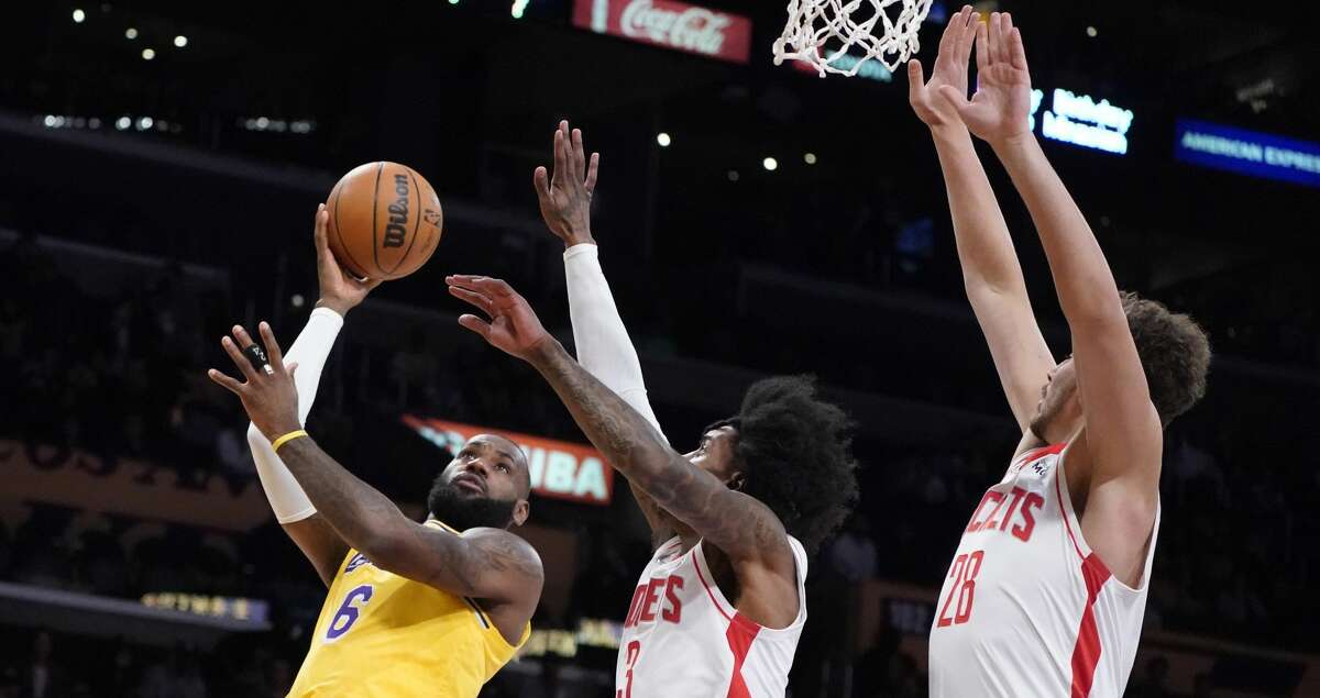 Los Angeles Lakers forward LeBron James (6) shoots over Houston Rockets guard Kevin Porter Jr. (3) and center Alperen Sengun (28) during the first half of an NBA basketball game Tuesday, Nov. 2, 2021, in Los Angeles. (AP Photo/Marcio Jose Sanchez)