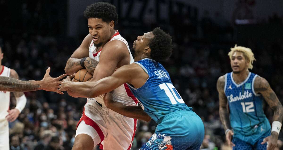 Houston Rockets guard Daishen Nix (15) is fouled by Charlotte Hornets guard Ish Smith (10) during the second half of an NBA basketball game Monday, Dec. 27, 2021, in Charlotte, N.C. (AP Photo/Matt Kelley)