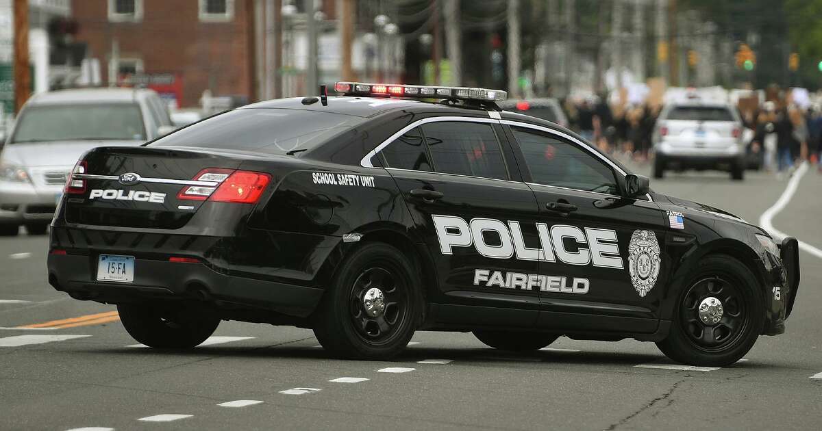 Police units searched the area near the Shell gas station on Post Road in Fairfield, Conn., for an individual accused of robbing the place at gunpoint Monday, Dec. 27, 2021.