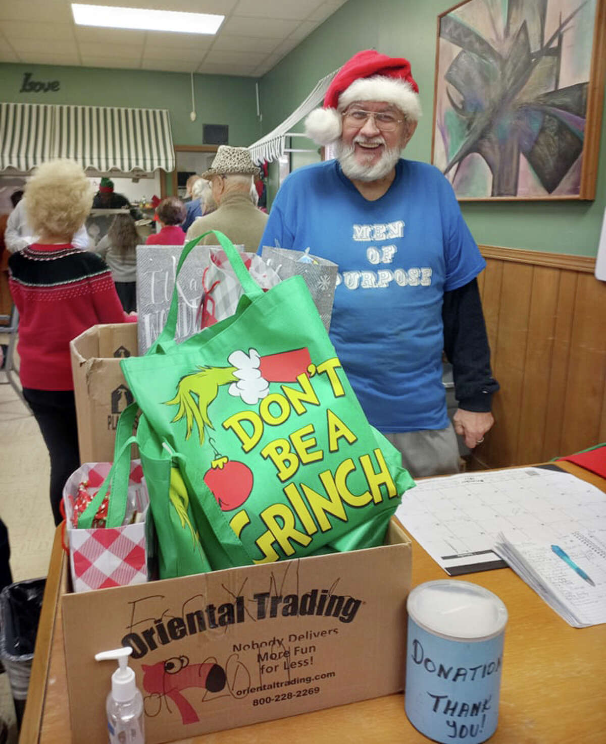 Volunteer Bill Bomar enjoys serving at the event, and pointed to gifts for children to receive on Christmas. 