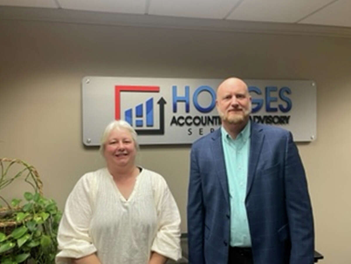 Laurie Messing with Lance Siemen of Hodges Accounting and Advisory Services, announcing the merger between their two accounting firms. Hodges Accounting also merged with the assets of Kenneth Baranski, who died in October.