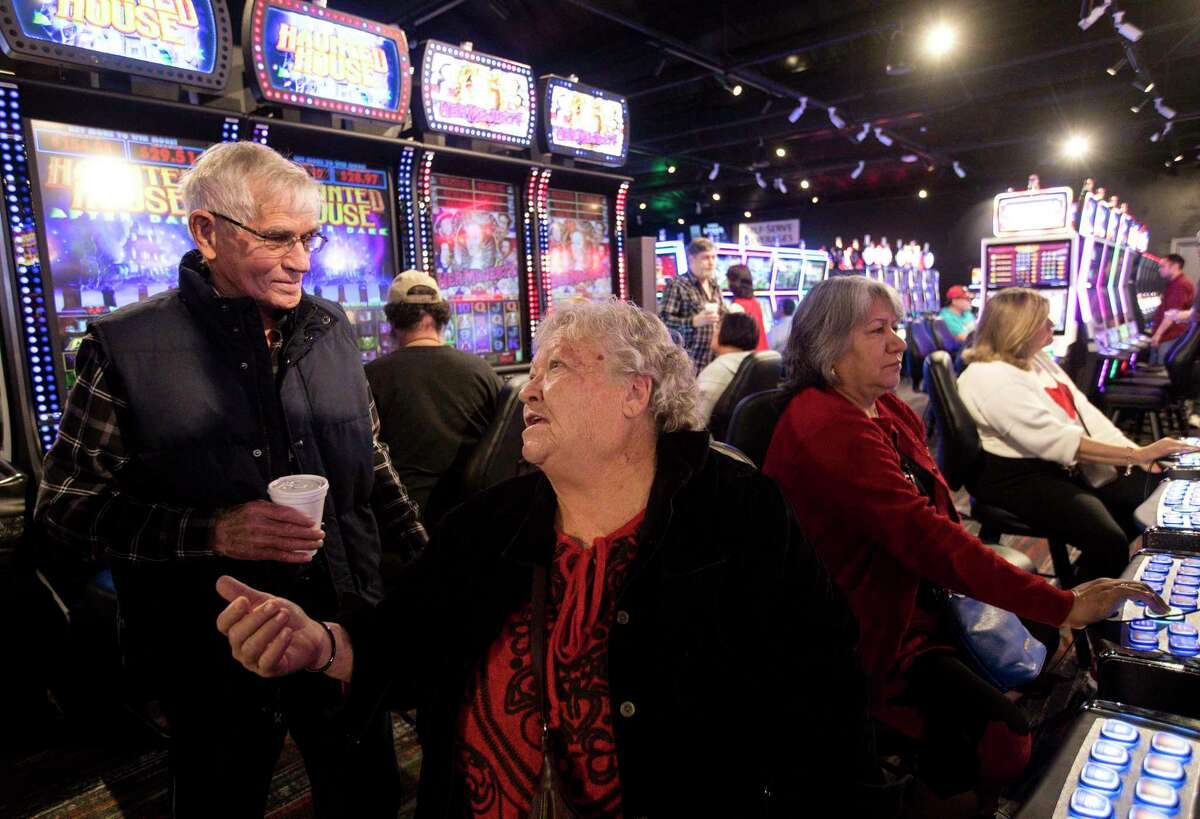 Martha Newton, front center, who lives in Polk County, talks with her neighbor Dean Nolen, left, as they play electronic games at Naskila Gaming, Wednesday, Feb. 14, 2018, near Livingston. 