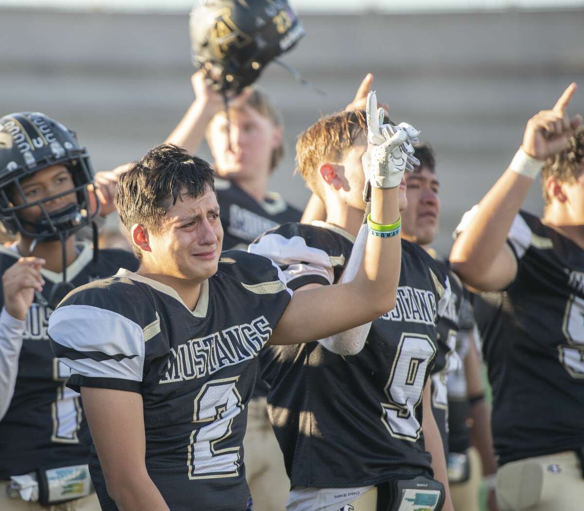 Andrews' players raise their hands as the Big Spring and Sweetwater bands play the Andrews school song following the 43-33 loss to Springtown 11/22/2021 at the Class 4A Division 1 area playoff at the Mustang Bowl in Sweetwater, Texas. Tim Fischer/Reporter-Telegram