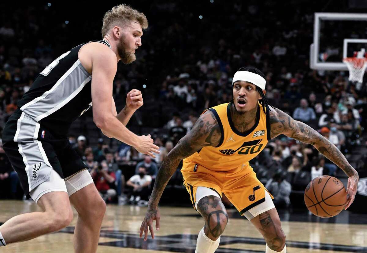 Utah’s Jordan Clarkson is defended by the Spurs’ Jock Landale in the Jazz’s 110-104 win Monday. A trash-talking fan was ejected during the game after Clarkson confronted him when he went too far with his comments.