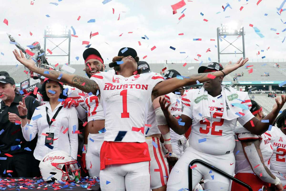 Houston wide receiver Nathaniel Dell (1) celebrates with teammates after the defeated Auburn in the Birmingham Bowl NCAA college football game Tuesday, Dec. 28, 2021, in Birmingham, Ala. (AP Photo/Butch Dill)