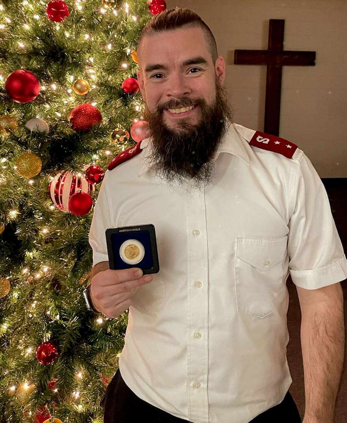 Salvation Army Capt. Sean Grey with the half ounce gold coin. The coin's estimated value is between $800 and $900.
