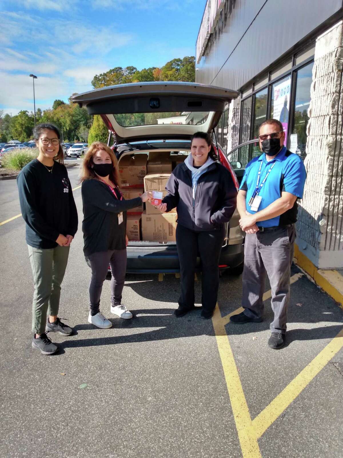 A representative from Halfway Home Rescue joins Ocean State Job Lot partners Tom Brown and Luana Onofrio to accept a donation from the Ocean State Jot Lot 'To the Rescue' animal donation program.