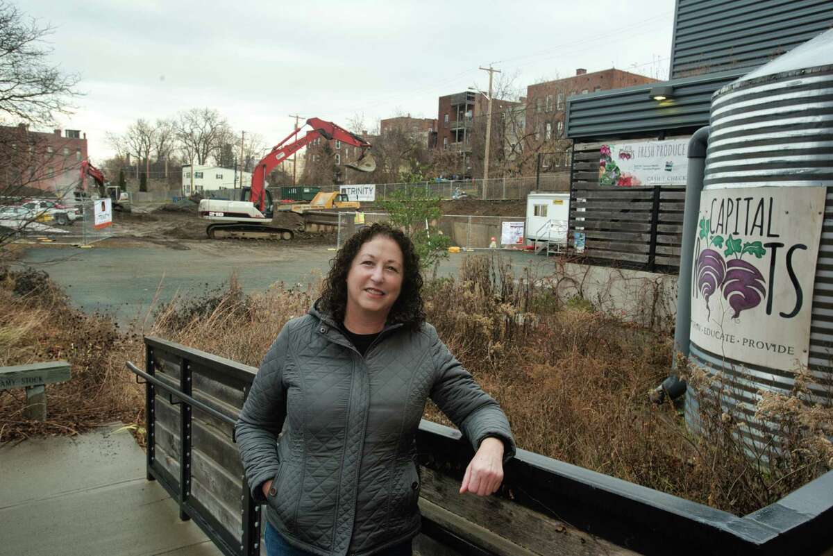 Amy Klein, CEO of Capital Roots, outside the organizations Urban Grow Center on Tuesday, Dec. 28, 2021, in Troy, N.Y. In the background construction has begun on what will be the expanded grow center and food market.