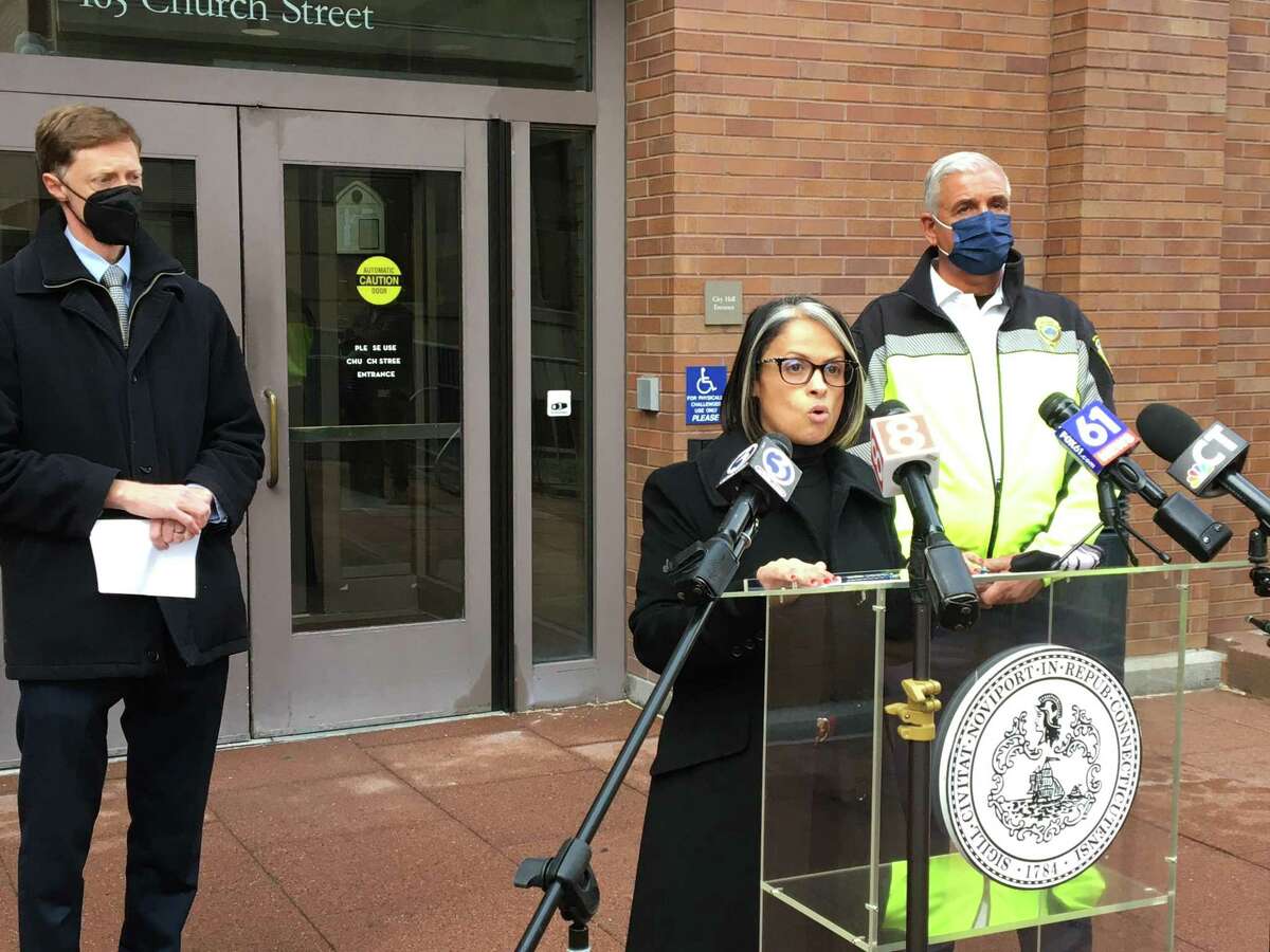 Director of Health Maritza Bond, center, talks about the upcoming distribution of free COVID-19 rapid tests outside the rear entrance to City Hall on Tuesday, Dec. 28, 2021. Joining her are New Haven Mayor Justin Elicker, left, and Director of Emergency Operations Rick Fontana, right.