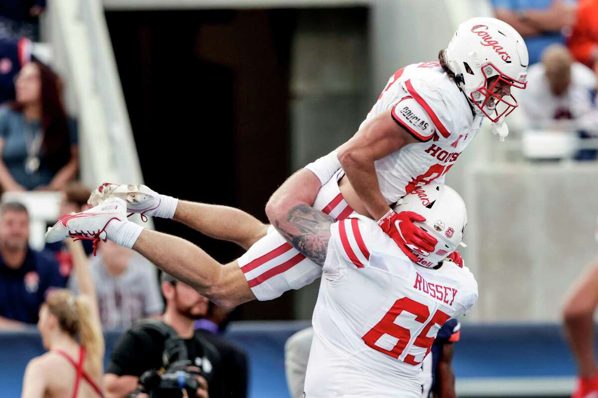 UH wide receiver Jake Herslow (87) celebrates with teammate Kody Russey (65) after scoring the winning touchdown against Auburn during Tuesday's Birmingham Bowl. 