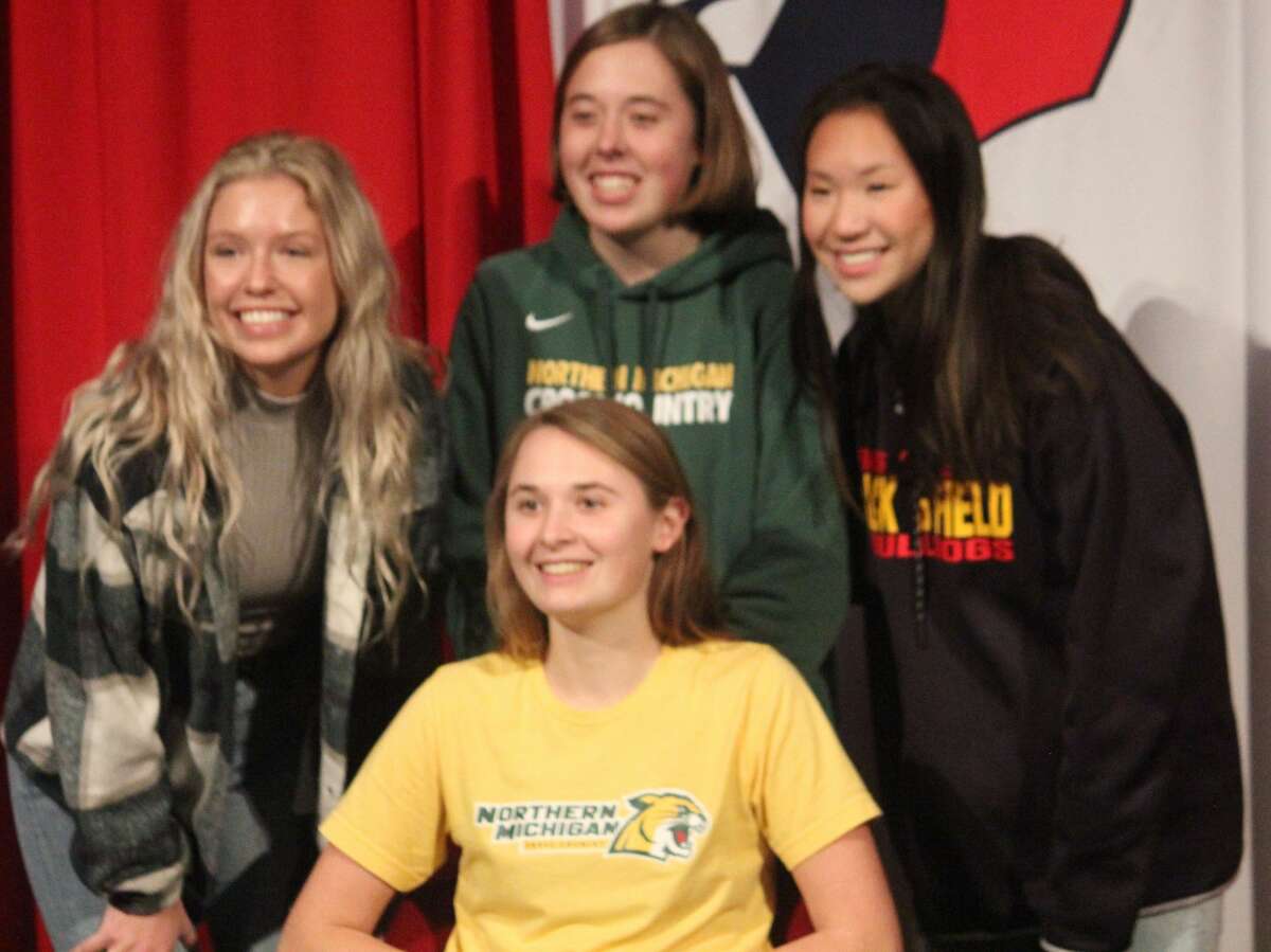 When Big Rapids senior Kate Langworthy (front) signed a letter earlier this month to run cross country and track at Nothern Michigan, former Cardinals who joined her were, back Hanna Brock (left) and Madi Hammer (right) now at Ferris, and her sister Meghan (center)  now at Northern.