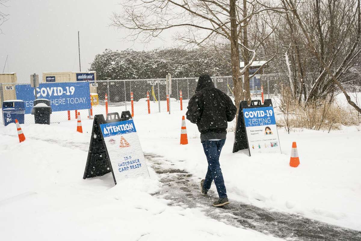 A patient enters a COVID-19 testing site on February 13, 2021 in Seattle, Washington. A large winter storm dropped heavy snow across the region. (Photo by David Ryder/Getty Images)