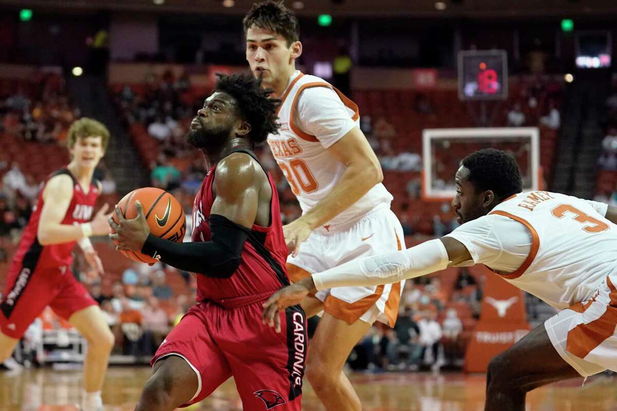 Incarnate Word guard RJ Glasper, left, drives past Texas guard Courtney Ramey (3) during the first half of an NCAA college basketball game, Tuesday, Dec. 28, 2021, in Austin, Texas. (AP Photo/Eric Gay)