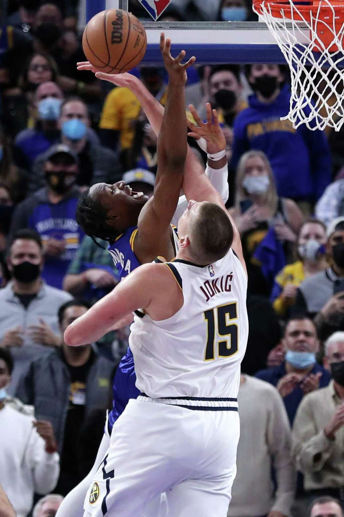 Golden State Warriors' Jonathan Kuminga can't score tying basket in final seconds of 4th quarter against Denver Nuggets' Nikola Jokic during Nuggets' 89-86 win in NBA game at Chase Center in San Francisco, Calif., on Tuesday, December 28, 2021.