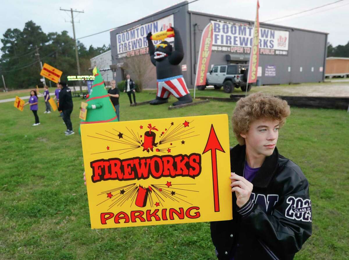 Willis High School band member Benjamin Bright holds up a sign along Highway 75 in front of Boomtown Fireworks, Tuesday, Dec. 28, 2021, in Willis. The business, ran by Willis High School students and their families serve as a fund raiser for the high school’s band boosters and Operation Graduation.