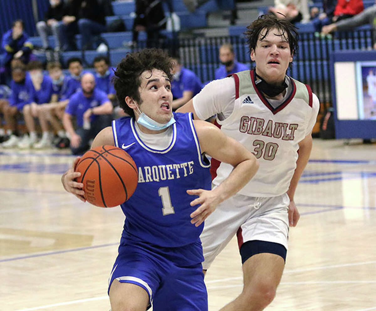 Marquette's Parker Macias (1) takes the ball to the basket after getting past Waterloo Gibault's Jude Green on Tuesday at the Columbia-Freeburg Tournament in Columbia.