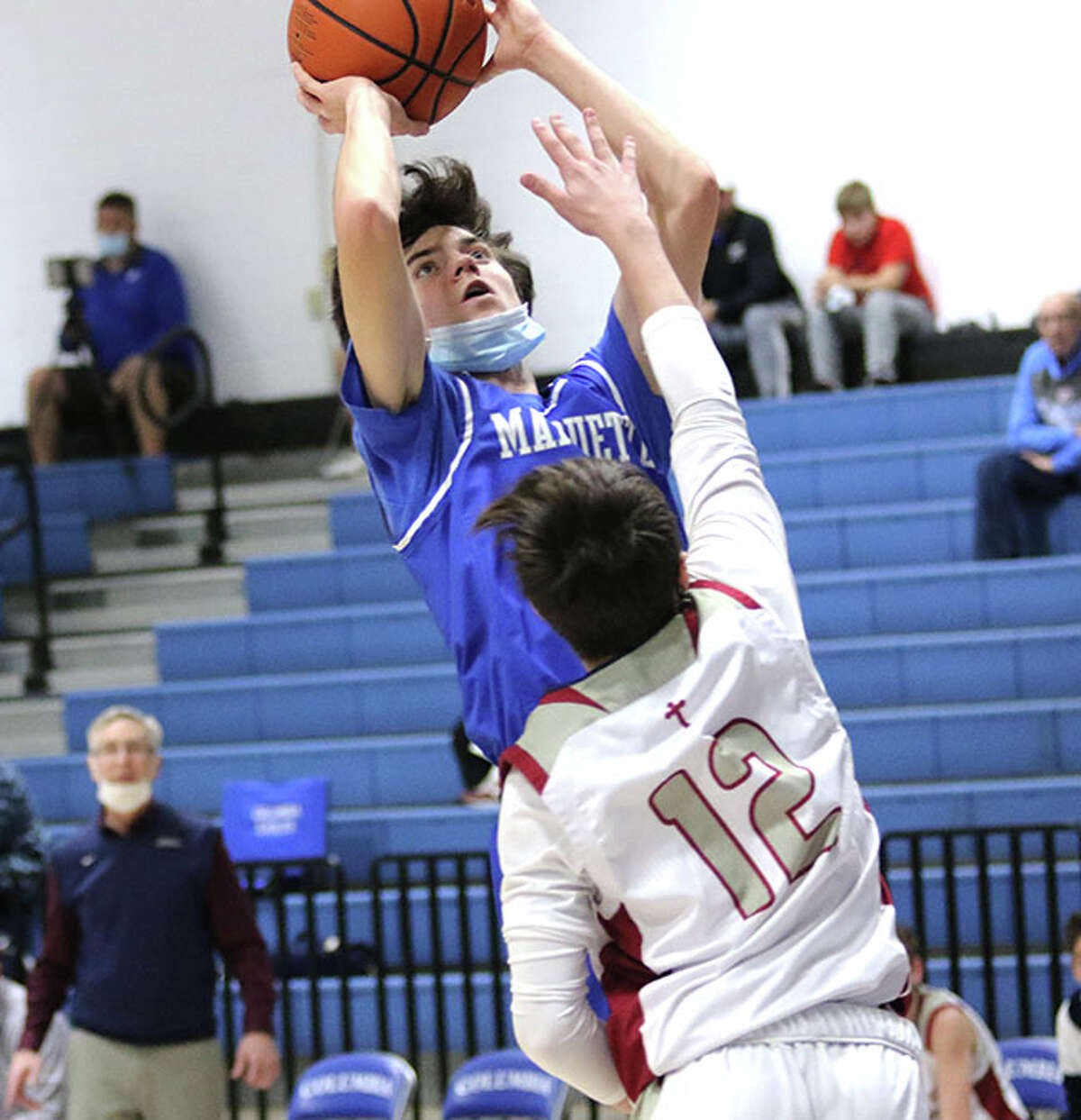 Marquette's Owen Williams scores over Waterloo Gibault's Kanen Augustine on Tuesday at the Columbia-Freeburg Tournament in Columbia.