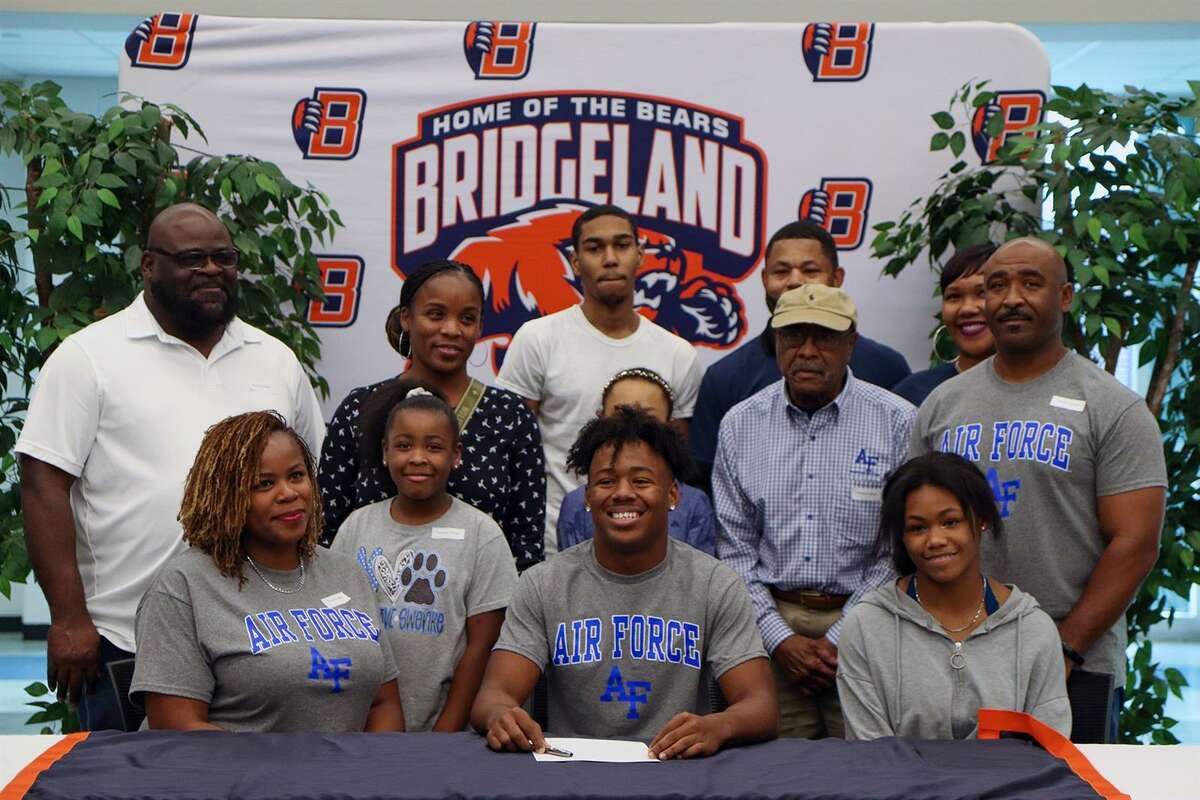 Bridgeland High School senior Terrance Cullivan, seated center, poses with his family after he signed his letter of intent on Dec. 15 to attend and play college football at the United State Air Force Academy. (Photo by Michelle Padilla, Bridgeland HS)
