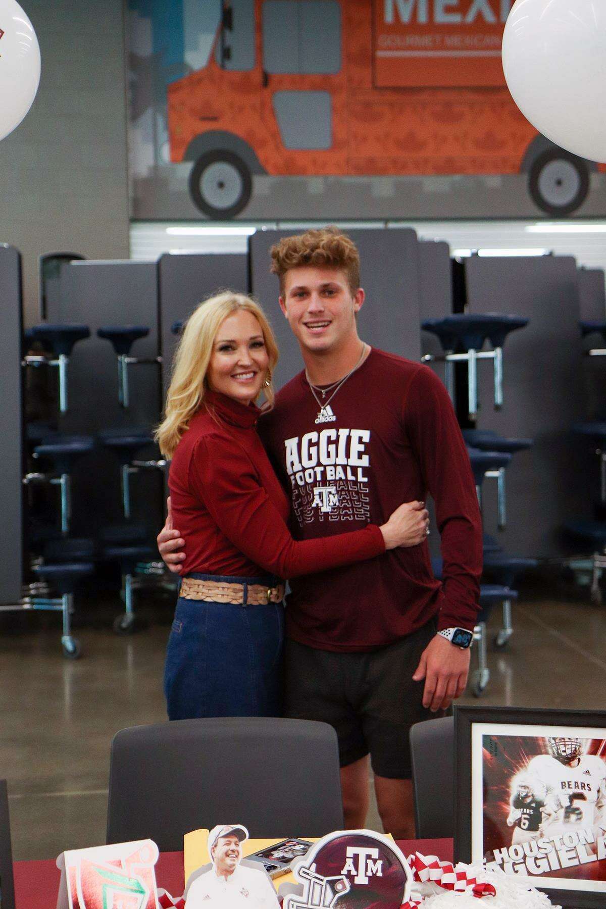 Bridgeland High School senior Andrew Maleski, right, smiles after signing a letter of intent to Texas A&MUniversity on Dec. 15. (Photo by Michelle Padilla, Bridgeland HS)