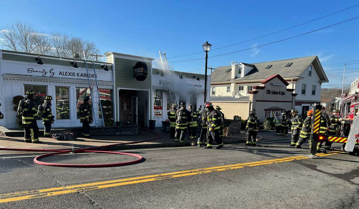 Firefighters respond to a blaze at Fuoco Apizza in Cheshire, Conn. Dec. 28, 2021