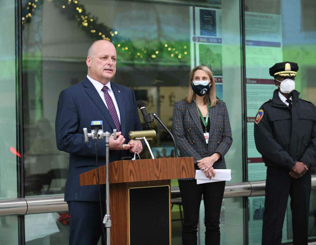 Stamford Director of Public Safety, Health and Welfare Ted Jankowski speaks beside Stamford Mayor Caroline Simmons and Stamford Police Asst. Chief Silas Redd at a press conference outside the Government Center in Stamford, Conn. Wednesday, Dec. 29, 2021. Stamford received a $550,000 grant from the U.S. Department of Justice to help the Stamford Police Department improve public safety responses for those with mental health and substance abuse issues. The grant will allow the Stamford Police Department to hire social workers to assist officers responding to pertinent calls to conduct mental health assessments, coordinate care, and provide referrals for those in need of assistance.