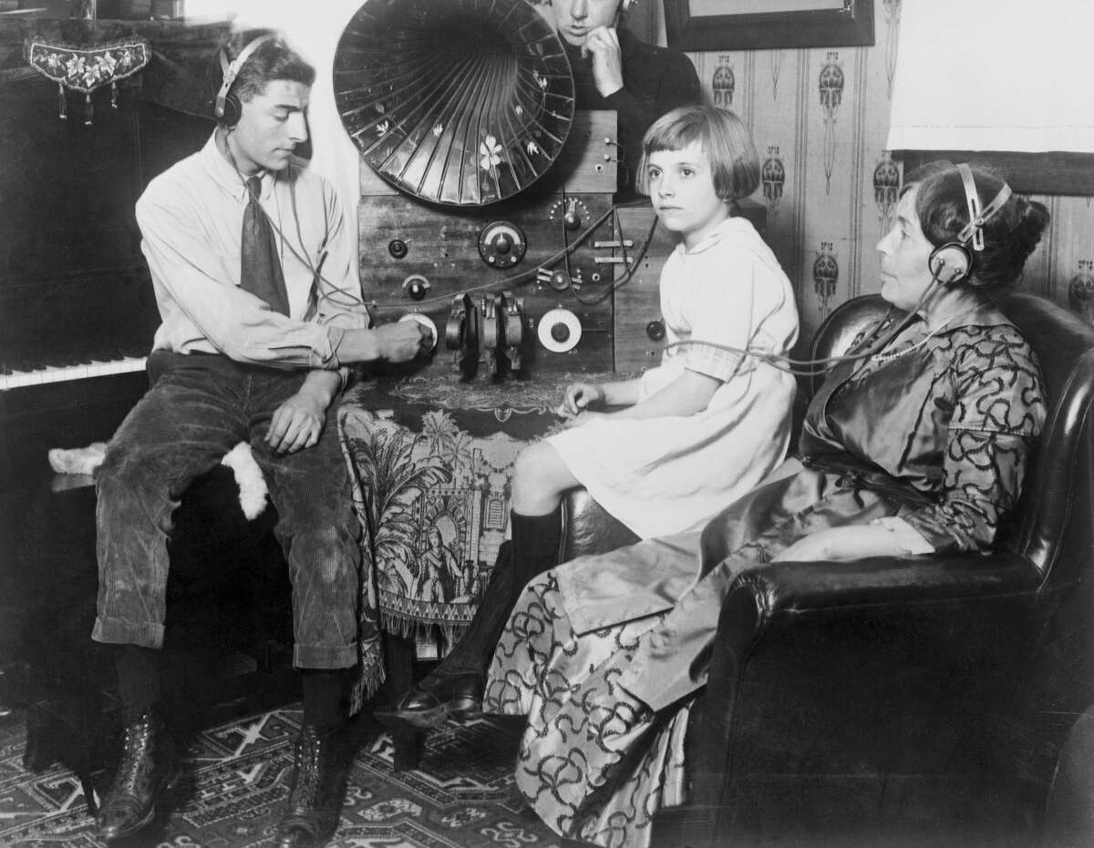 A San Francisco family gathers in their parlor to listen to a concert on their Victrola. 