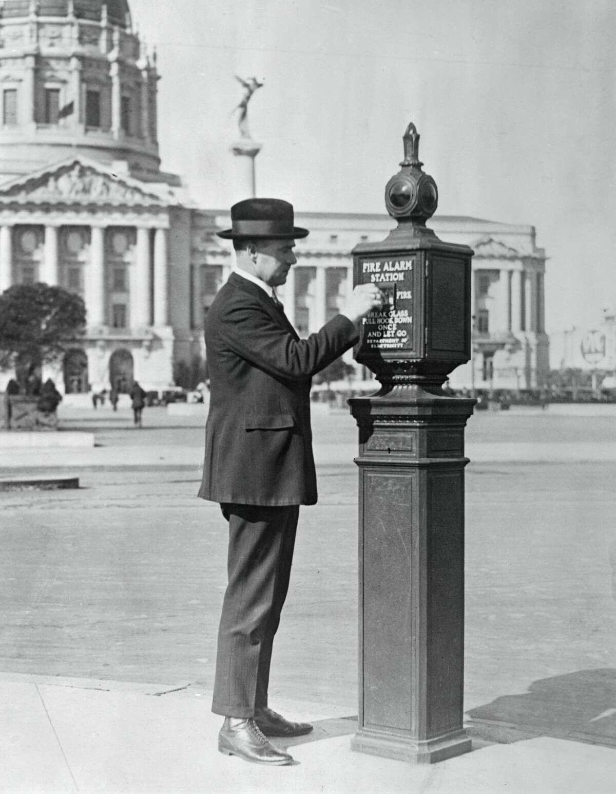 A man tests out a new invention from the San Francisco Fire Department: a call box.