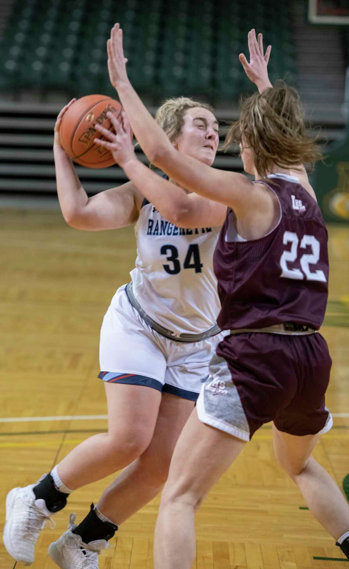Greenwood's Emma Dunn drives the lane as Legacy High's Maggie Erdwurm defends 12/29/2021 during the Byron Johnston Holiday Classic at the Chaparral Center. Tim Fischer/Reporter-Telegram