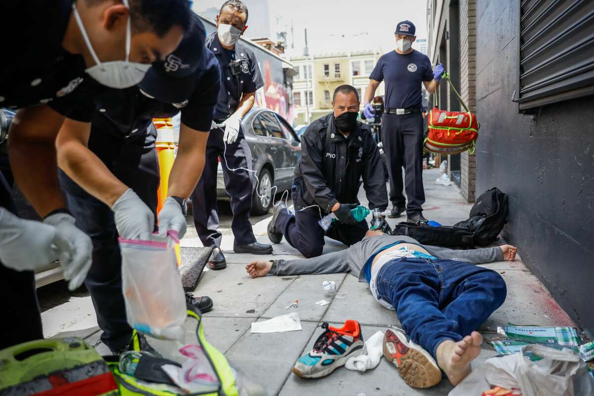Lieutenant firefighter and PIO Jonathan Baxter work to save man named Ryan during a fentanyl overdose on Olive Street in San Francisco, California.