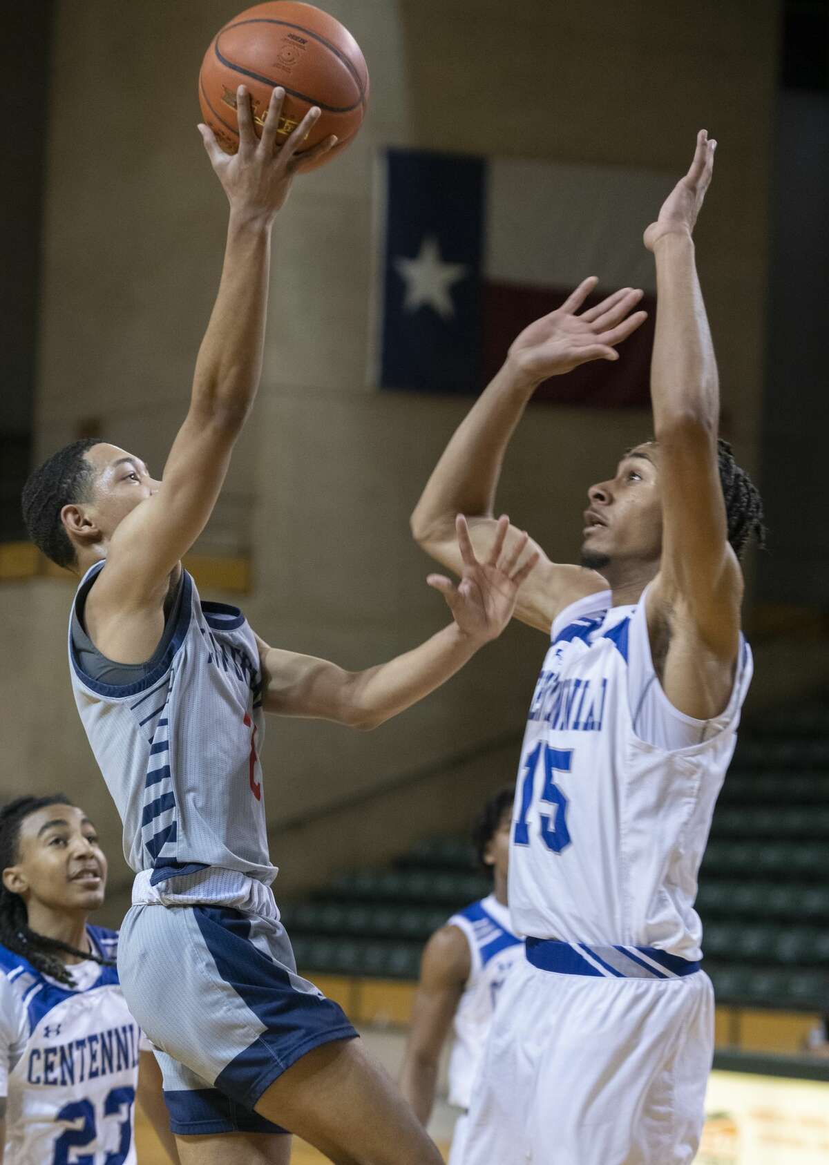 Plainview's Maddoz Ellis drives in for a layup as Burleson Centennial's Jordan Jenkins defends 12/29/2021 during the Byron Johnston Holiday Classic at the Chaparral Center. Tim Fischer/Reporter-Telegram