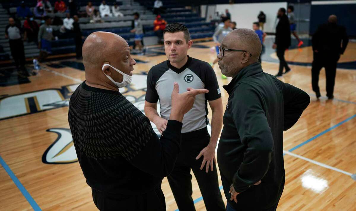 Head coach Greg Wise, left, of Jack Yates Houston talks with Minneapolis North coach Larry McKenzie , in Minneapolis, Minn., on Tuesday, Dec. 28, 2021. Minneapolis North boys' basketball played Houston (Texas) Yates High School in a tournament played at North Central University called the George Floyd Memorial Holiday Classic. Houston Yates was the high school Floyd played for back in the day.