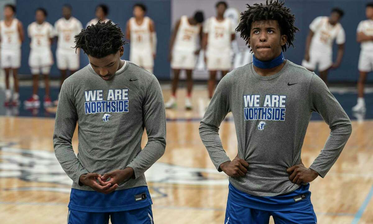 Minneapolis North players Zaeshon (cq) Rich, left and Willie Wilson stood during the playing of the national anthem , in Minneapolis, Minn., on Tuesday, Dec. 28, 2021. Minneapolis North boys' basketball played Houston (Texas) Yates High School in a tournament played at North Central University called the George Floyd Memorial Holiday Classic. Houston Yates was the high school Floyd played for back in the day.