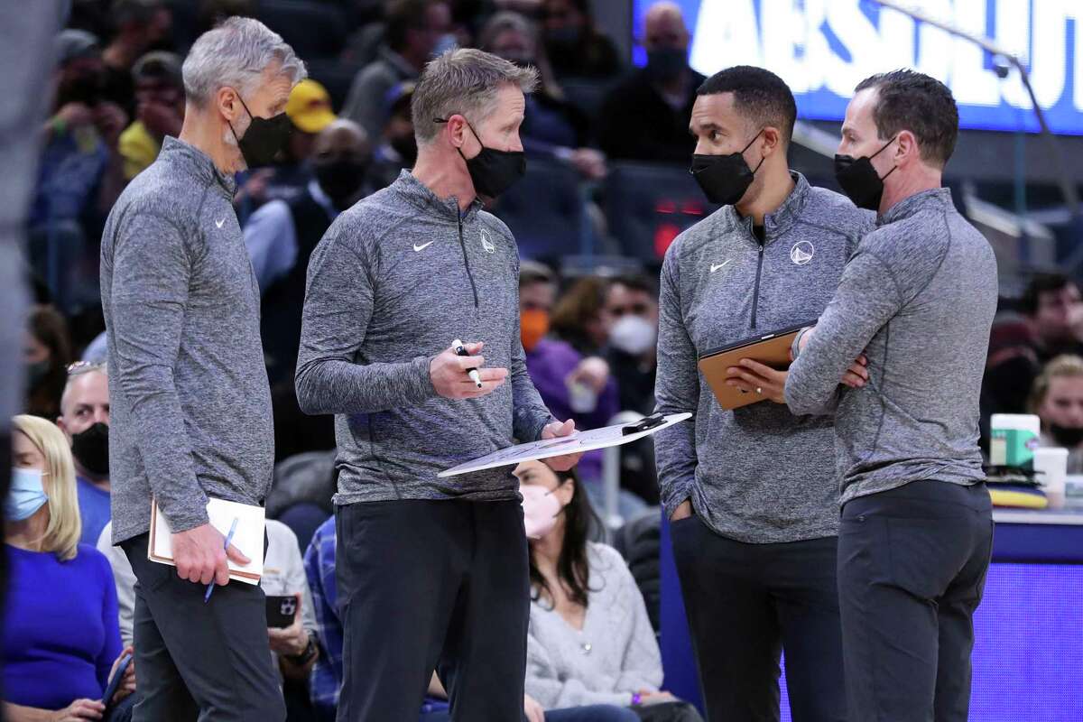 Golden State Warriors' player development coach Jama Mahlalela (second from right) huddles with head coach Steve Kerr, and assistant coaches Bruce Fraser and Kenny Atkinson during game against Denver Nuggets at Chase Center in San Francisco, Calif., on Tuesday, December 28, 2021.