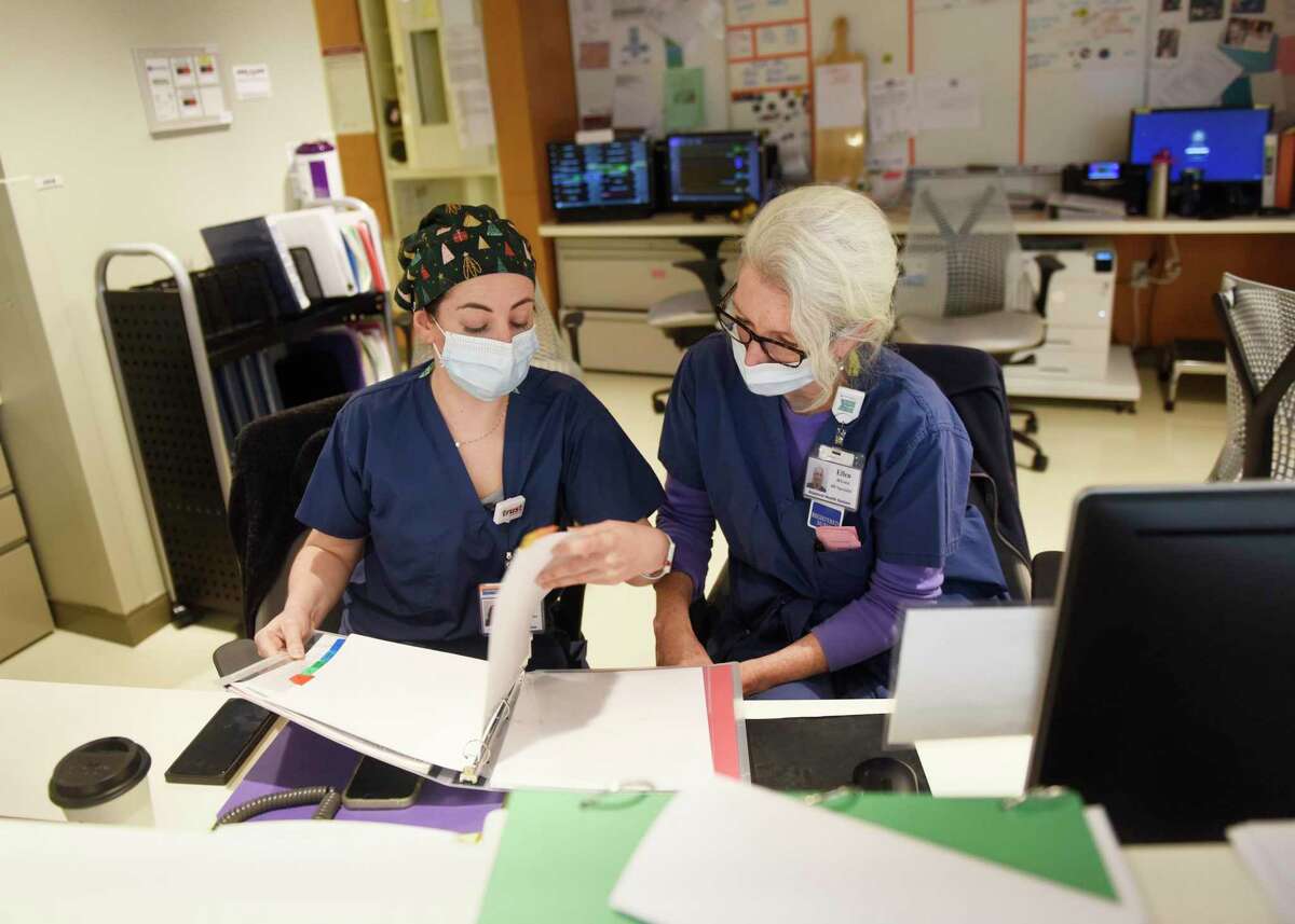 Casey Lorusso, RN, left, and Ellen deLuca, RN, work in the nurses station at Stamford Hospital on Dec. 20. With another full year of COVID in the books, Stamford Hospital has endured the challenges and made great progress in other areas.