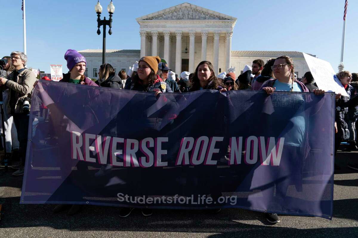 Anti-abortion protesters demonstrate in front of the U.S. Supreme Court Dec. 1, 2021, in Washington, as the court hears arguments in a case from Mississippi, where a 2018 law would ban abortions after 15 weeks of pregnancy, well before viability. An expected decision by the U.S. Supreme Court in the coming year to severely restrict abortion rights or overturn Roe v. Wade entirely is setting off a renewed round of abortion battles in state legislatures.